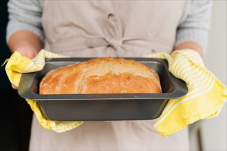Woman holding freshly baked bread