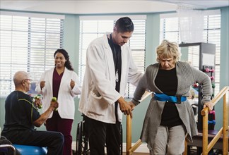 Senior people exercising with therapists during physical therapy