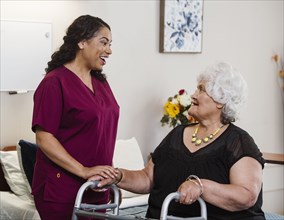 Nurse talking to senior woman in nursing home