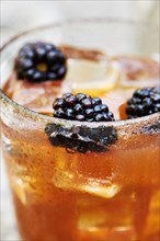 Blackberries in whiskey cocktail