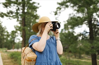 USA, Utah, Bryce Canyon, Woman photographing with digital camera in national park