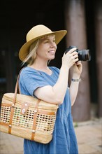 Woman holding digital camera