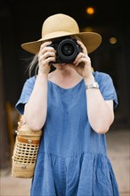 Woman photographing with digital camera