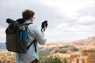 USA, Utah, Bryce Canyon, Man recording video in national park