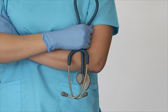 Nurse with hands crossed holding stethoscope