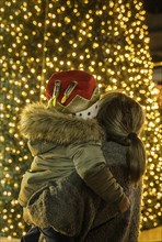 Mother and son watching illuminated Christmas tree