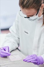 Female technician working with tests