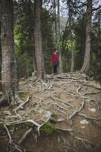 Switzerland, Bravuogn, Palpuognasee, Young woman standing in forest