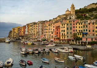 Italy, Cinque Terra, Boats in harbor with town in background