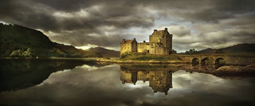 United Kingdom, Scotland, Medieval castle reflecting in lake