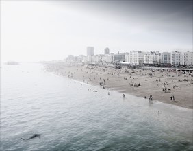 England, Brighton, People resting at urban beach
