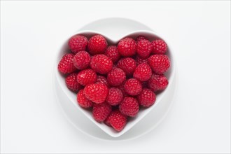Raspberries in heart-shaped bowl