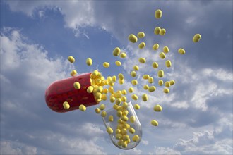 Capsule with yellow pills inside with clouds as background