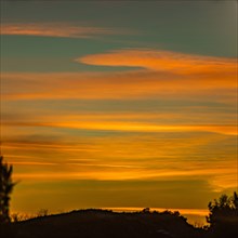 USA, Idaho, Boise, Orange sunset over hill
