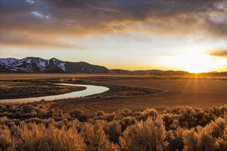 USA, Idaho, Picabo, Sunset over plain and mountain range
