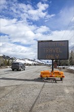 USA, Idaho, Sun Valley, COVID_19 lockdown on travel electronic sign on roadside