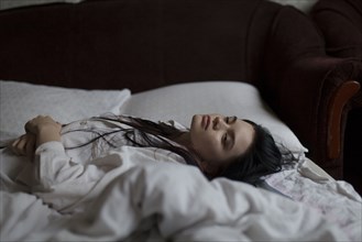 Young woman lying on bed