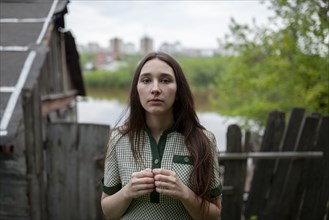 Russia, Omsk, Portrait of young woman in backyard