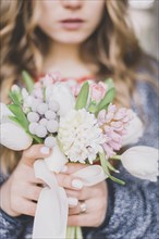 Close up of bride holding bouquet of flowers