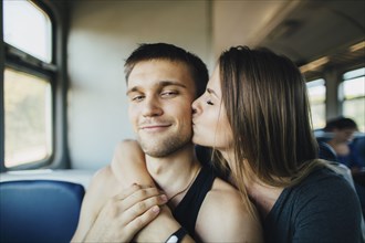 Young couple kissing in train