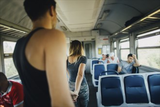 Young couple walking inside of train