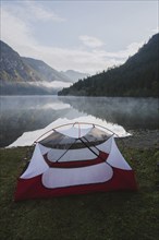 Austria, Plansee, Tent by lake Plansee at sunrise