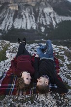 Ukraine, Crimea, Young couple lying down at plaid near canyon