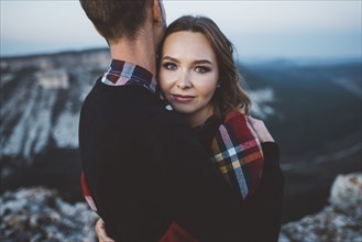 Ukraine, Crimea, Young couple hugging near canyon