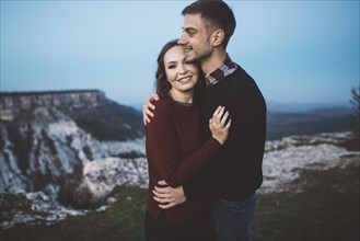 Ukraine, Crimea, Young couple hugging near canyon