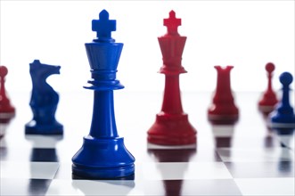 Studio shot of red and blue chess pawns symbolizing US Democratic and Republican parties