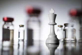 Chess king and laboratory vials