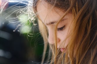 Close-up of girl (6-7) with wind blow hair