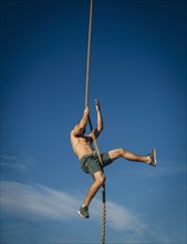 Man climbing on rope