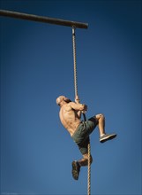 Man climbing on rope