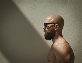 Profile of bald muscular man