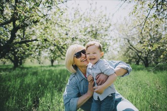 Mother with son (2-3) in orchard