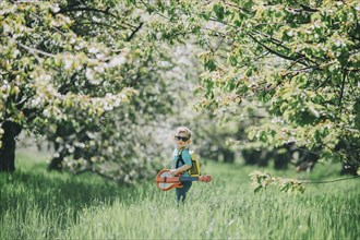 Boy (2-3) in orchard