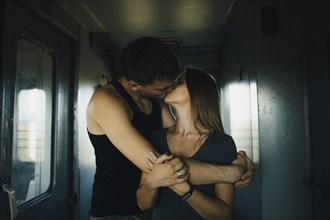 Couple kissing on train