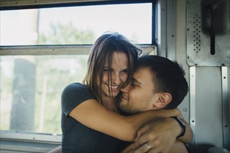 Couple embracing on train