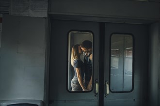 Couple kissing on train