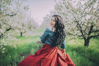 Young woman in blooming orchard