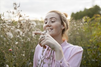 Russia, Omsk, Young woman in meadow