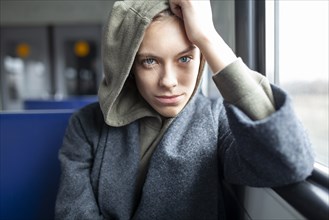 Portrait of young woman in train