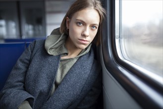 Portrait of young woman in train