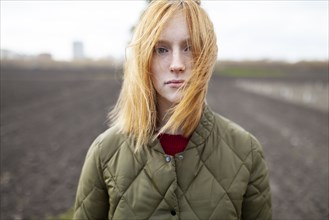 Russia, Omsk, Portrait of young woman in field