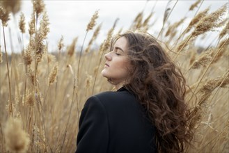 Young woman in tall grass