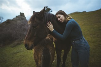 Ukraine, Crimea, Young woman embracing Icelandic horse