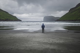 Denmark, Man standing on beach in foggy day,