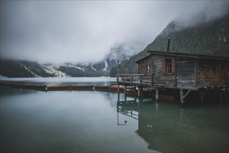 Italy, Wooden house and boats at Pragser Wildsee,