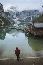 Italy, Man standing at Pragser Wildsee in Dolomites,